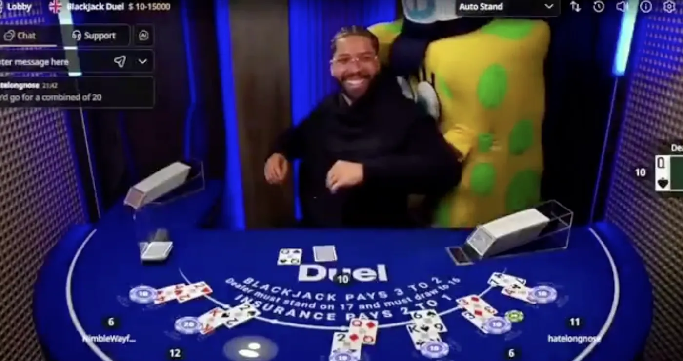 A player tackled by a giant mascot at a Duel Blackjack table mid-hand