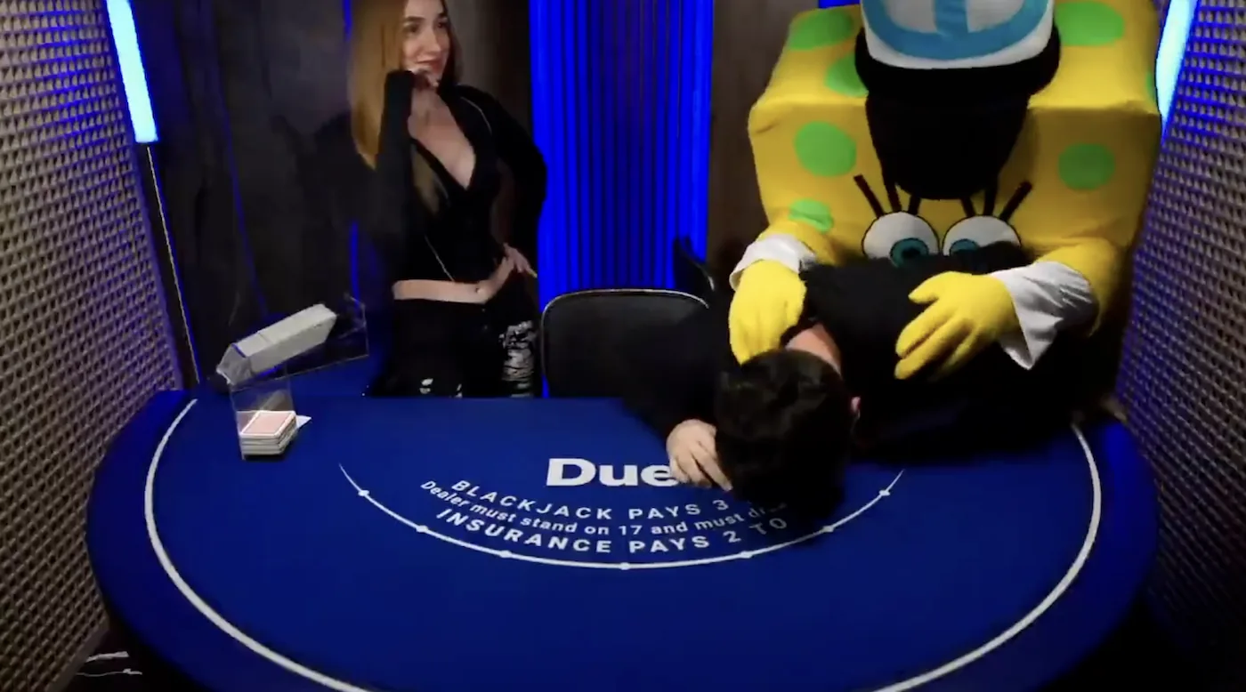 A Duel Blackjack dealer and player with a giant mascot crashing the table